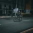 A cyclist rides down a dark city street.