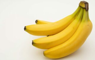 a bunch of bananas sitting on top of a white table