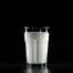 A glass of fresh milk against a black background, emphasizing simplicity and nutrition.